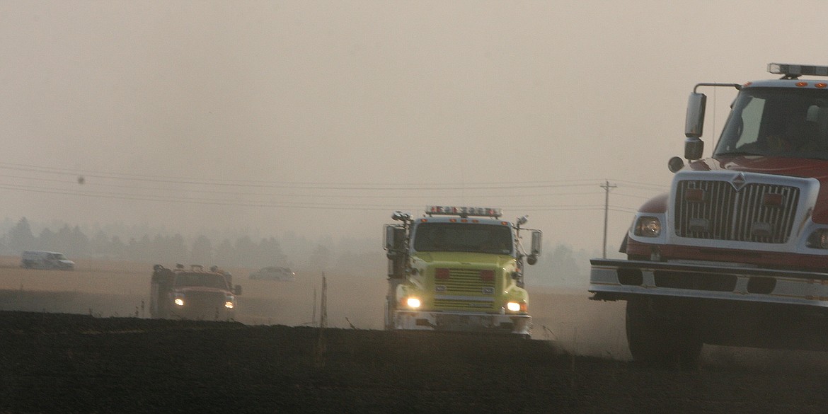 Crews from Kootenai County Fire and Rescue, Idaho Department of Lands and Northern Lakes tag-teamed a wheat field fire east of Highway 41 Tuesday night. Safety chains from a semi that had pulled over are believed to have caused the fire. (BRIAN WALKER/Press)