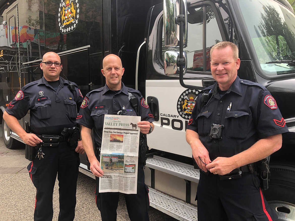 Officers from the Calgary Police Department are happy to have a quick read of the Valley Press. (Erin Jusseaume/Clark Fork Valley Press)