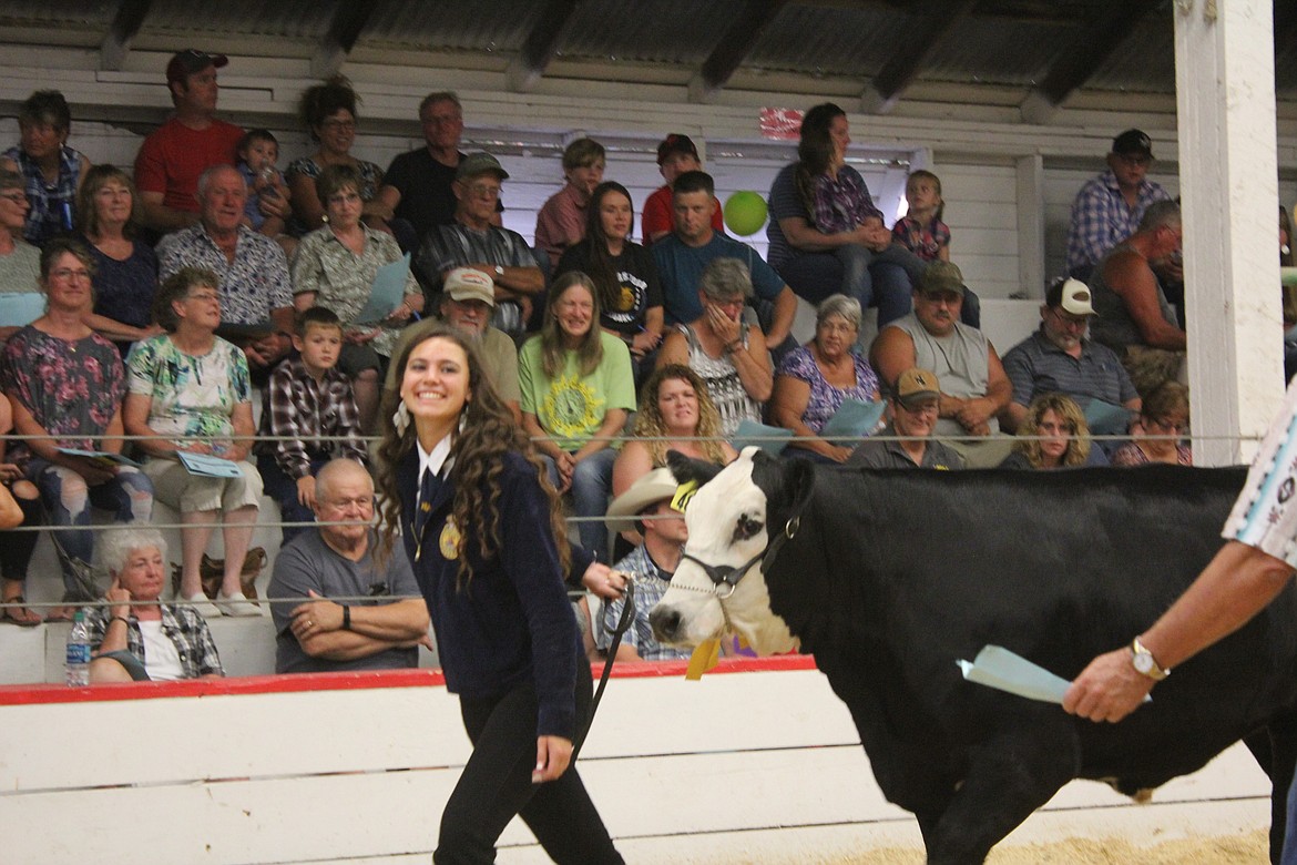 Photo by TANNA YEOUMANS
Sydney Nelson beams at the crowd while leading her 1152 lb. steer.