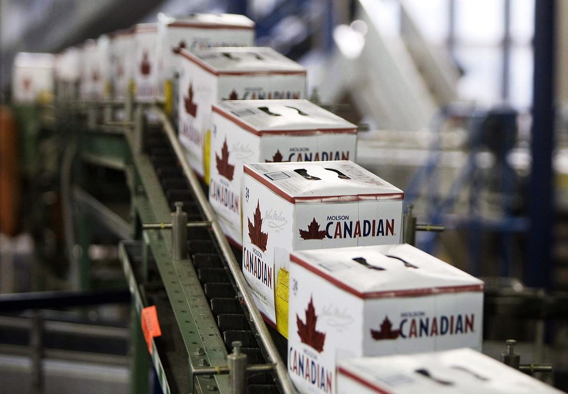 FILE - In this Jan. 26, 2010, file photo, cans of Molson Canadian are boxed along the can line at the Molson Breweries in Vancouver, British Columbia. Molson Coors Brewing Company says it is not giving away free beer, despite a coupon offer circulating online. The false offer asks users to fill out a survey to win a free 24-pack of beer. Jessica Teixeira, a Molson Coors spokeswoman, told The Associated Press that the website &quot;is absolutely not genuine, nor is it run or endorsed by Molson Coors.&quot; (Jonathan Hayward/The Canadian Press via AP, File)