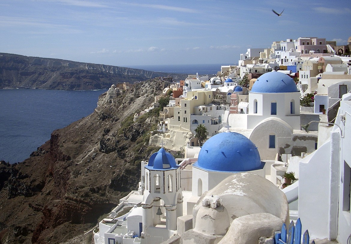 FILE - This Sept. 21, 2009, file photo, shows a view of Oia village on the island of Santorini, Greece. Mules are not being bred with donkeys to create a stronger animal to carry overweight tourists on the steep terrain of the Greek island Santorini, as several online news sites reported. (AP Photo/Michael Virtanen, File)