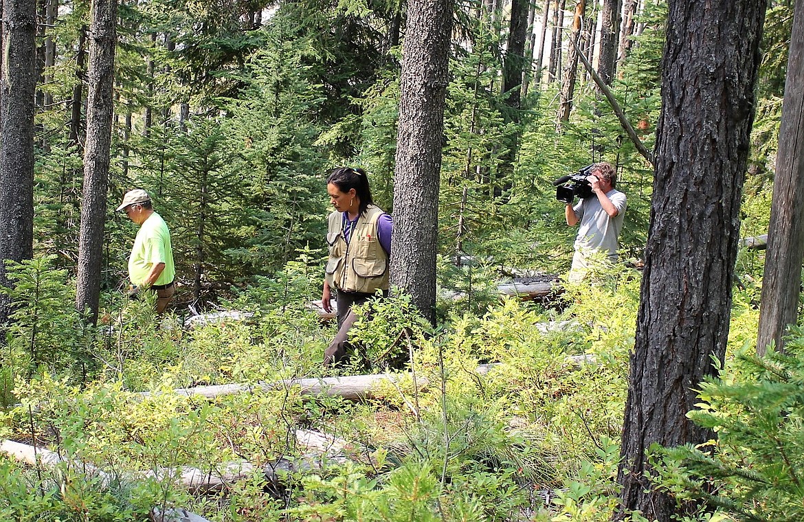 Montana PBS Producer Gus Chambers documents with archeologist Erika Karuzas and volunteer Steve Waylet as they search for the Taft cemetery near the Idaho-Montana border. (Kathleen Woodford/Mineral Independent)