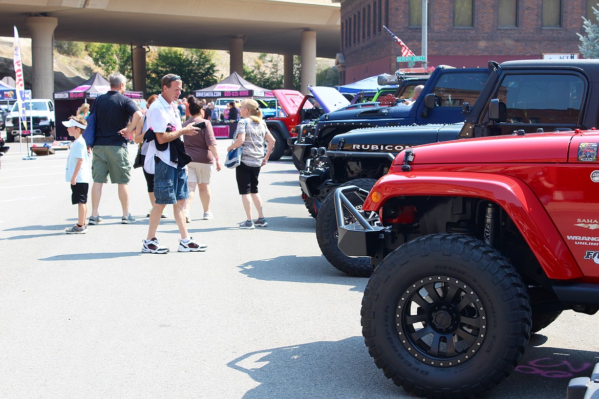 Photo by CHANSE WATSON
Jeep lovers check out the many Jeeps parked near City Hall in downtown Wallace for the first Dave Smith Jeep Fest.