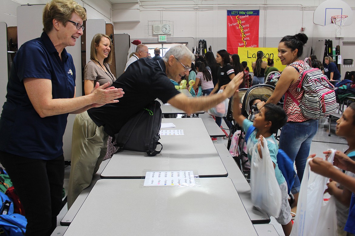 Cheryl Schweizer/Columbia Basin HeraldKids got new backpacks full of school supplies and high fives during the Back 2 School distribution at Larson Heights Elementary Friday.