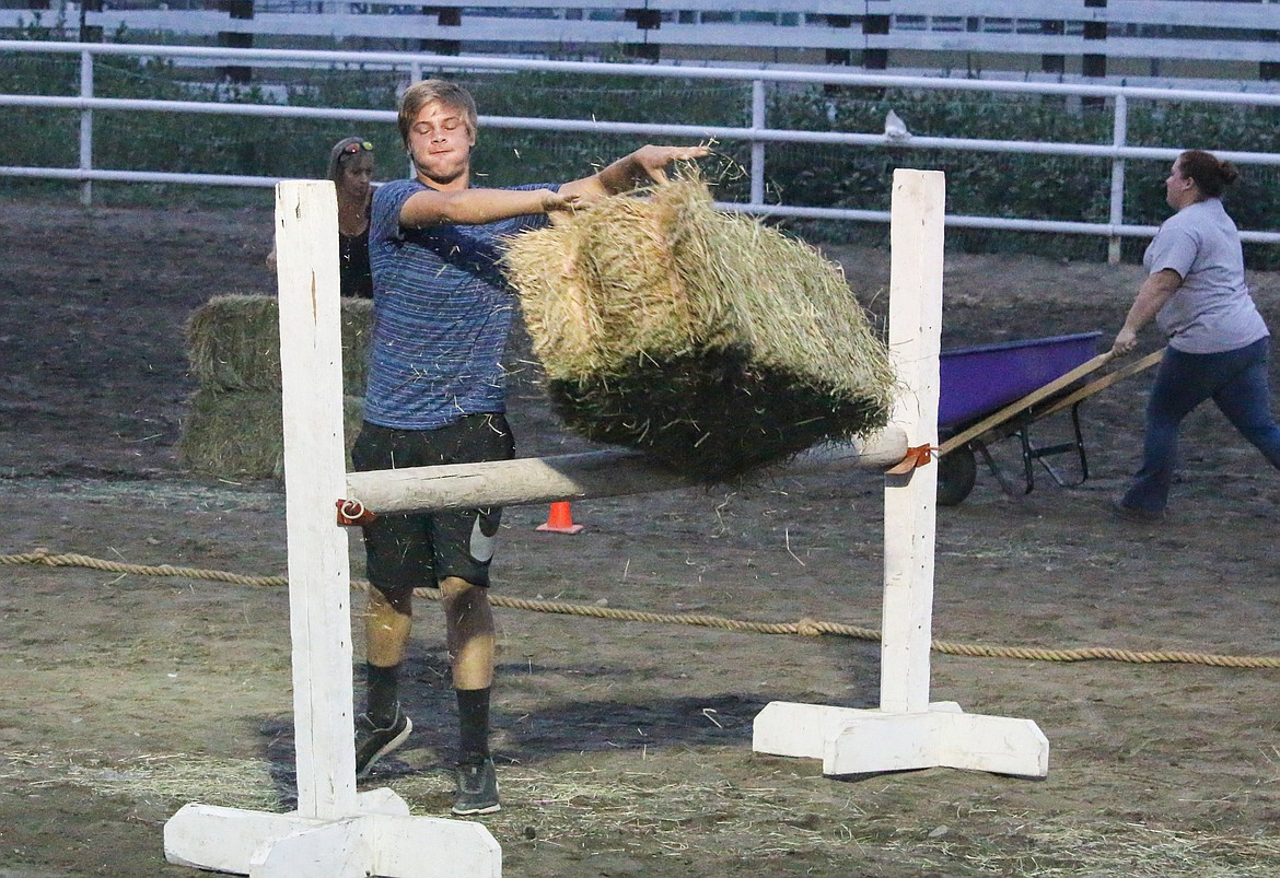 Photo by MANDI BATEMAN
Tossing hay bales as part of a race.