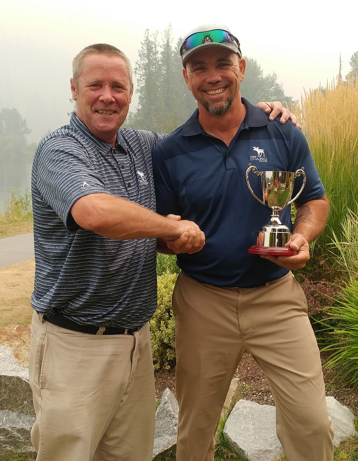 (Courtesy photo)
Idaho Club general manager Gordon Holmes, left, hands Clark Fork&#146;s Rich Harter the trophy last weekend after Harter carded rounds of 84 and 77 to post a two-day score of 161 en route to winning the Idaho Club men&#146;s championship. Harter was clutch, posting birdies on the final two holes to edge out local Dave Sanders by two strokes, while Sandpoint&#146;s Jim Troughton won the low net with a two round total of 140. The only Jack Nicklaus course in Idaho is in excellent condition right now, and open for play to the public after 11 a.m. each day.