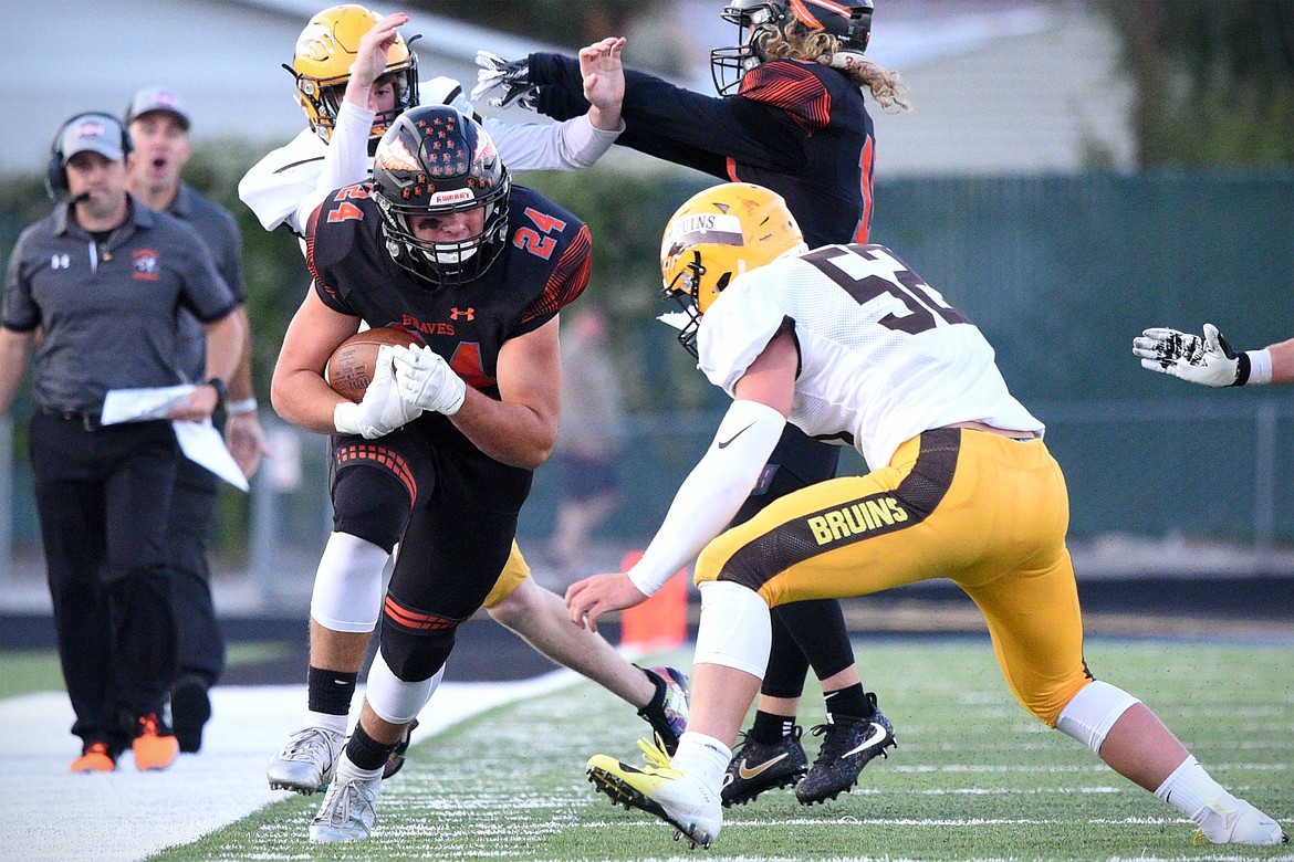 Flathead running back Blake Counts lowers his shoulder into Helena Capital linebacker Zane McCormick at Legends Stadium on Friday night. (Casey Kreider/Daily Inter Lake)