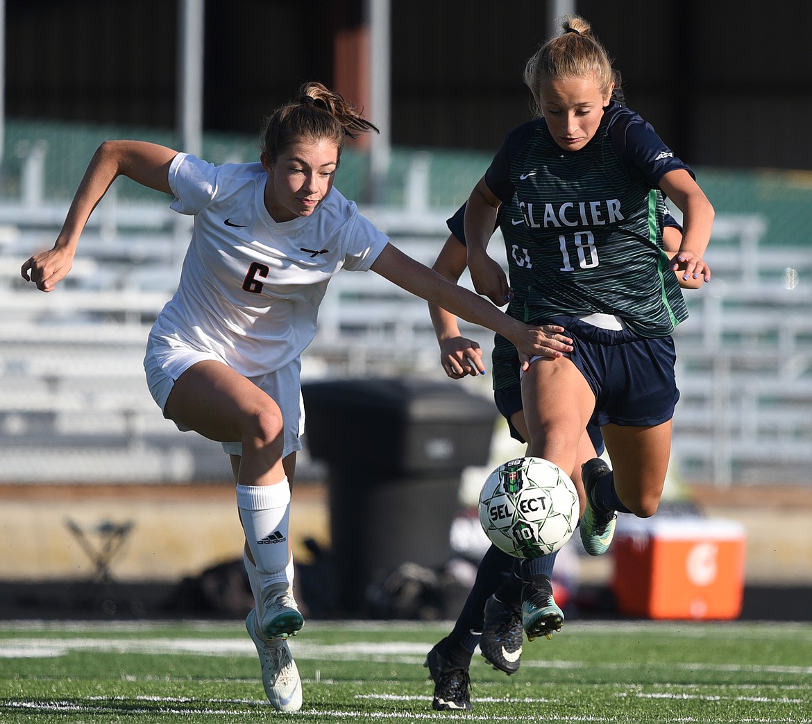 Glacier's Madison Becker (18) battles Flathead's True Gannon (6) during a crosstown matchup at Legends Stadium on Thursday. (Casey Kreider/Daily Inter Lake)