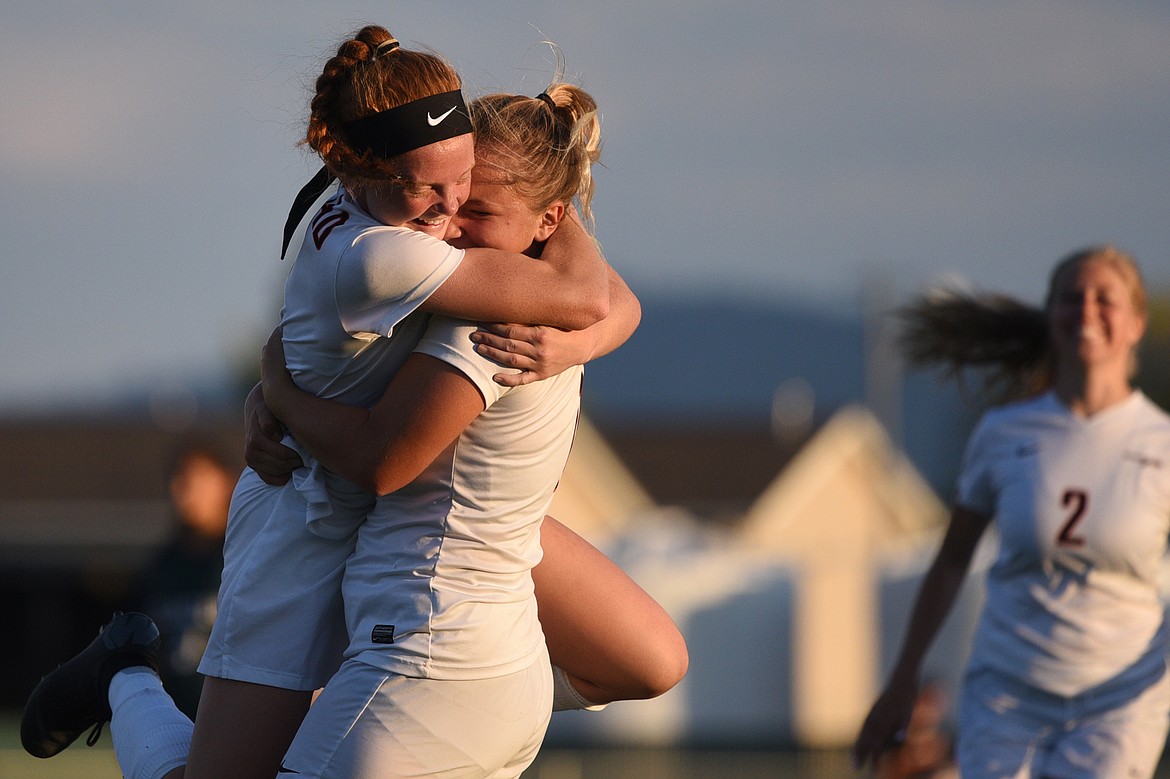 Flathead's Skyleigh Thompson, left, and Chloe Nadeau celebrate after Thompson's goal against Glacier during a crosstown matchup at Legends Stadium on Thursday. (Casey Kreider/Daily Inter Lake)