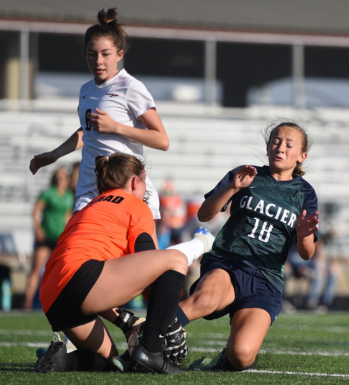 Glacier's Madison Becker collides with Flathead goalkeeper Aaris Hill during a crosstown matchup at Legends Stadium on Thursday. (Casey Kreider/Daily Inter Lake)