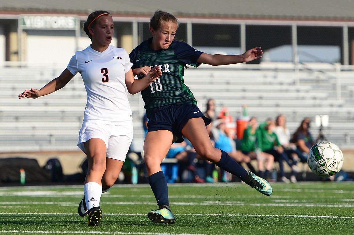 Glacier's Madison Becker scores a goal while being defended by Flathead's Rylee Barnes during a crosstown matchup at Legends Stadium on Thursday. (Casey Kreider/Daily Inter Lake)