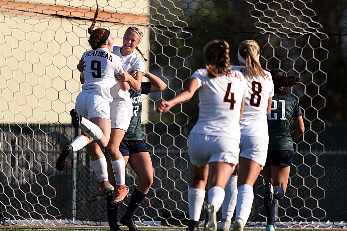 Flathead's Skyleigh Thompson (9) celebrates with Shayenn Thompson (10) after Shayenn Thompson's first-half goal against Glacier during a crosstown matchup at Legends Stadium on Thursday. (Casey Kreider/Daily Inter Lake)