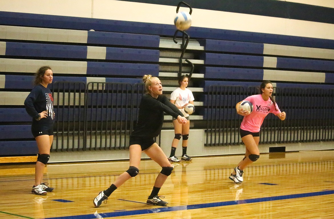 Rikki Cowine, Avery Pluid, Sydney Nelson and Sierra Hill practice serving and receiving serves.