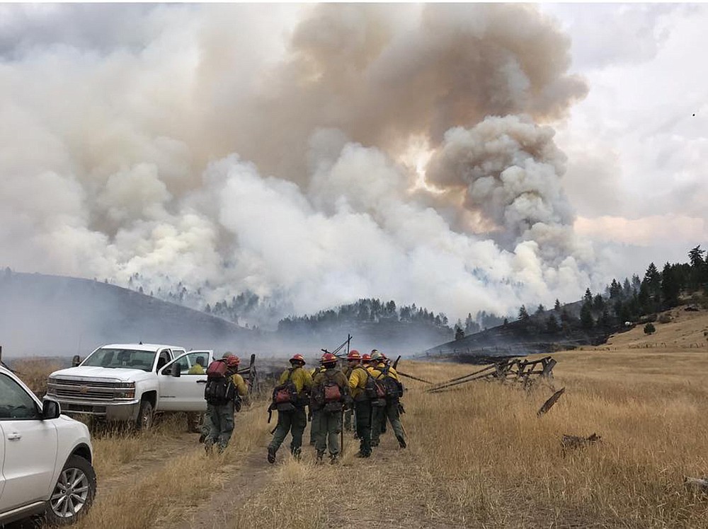 Firefighters from the Salish and Kootenai Tribes head to a new fire in the Rattlesnake area Thursday.