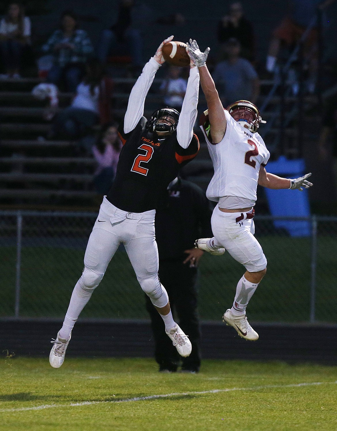 Post Falls wide receiver Jacob Rutherford catches a deep pass in front of University's Blake Tellinghusen during Friday night's game in Post Falls. (LOREN BENOIT/Press)