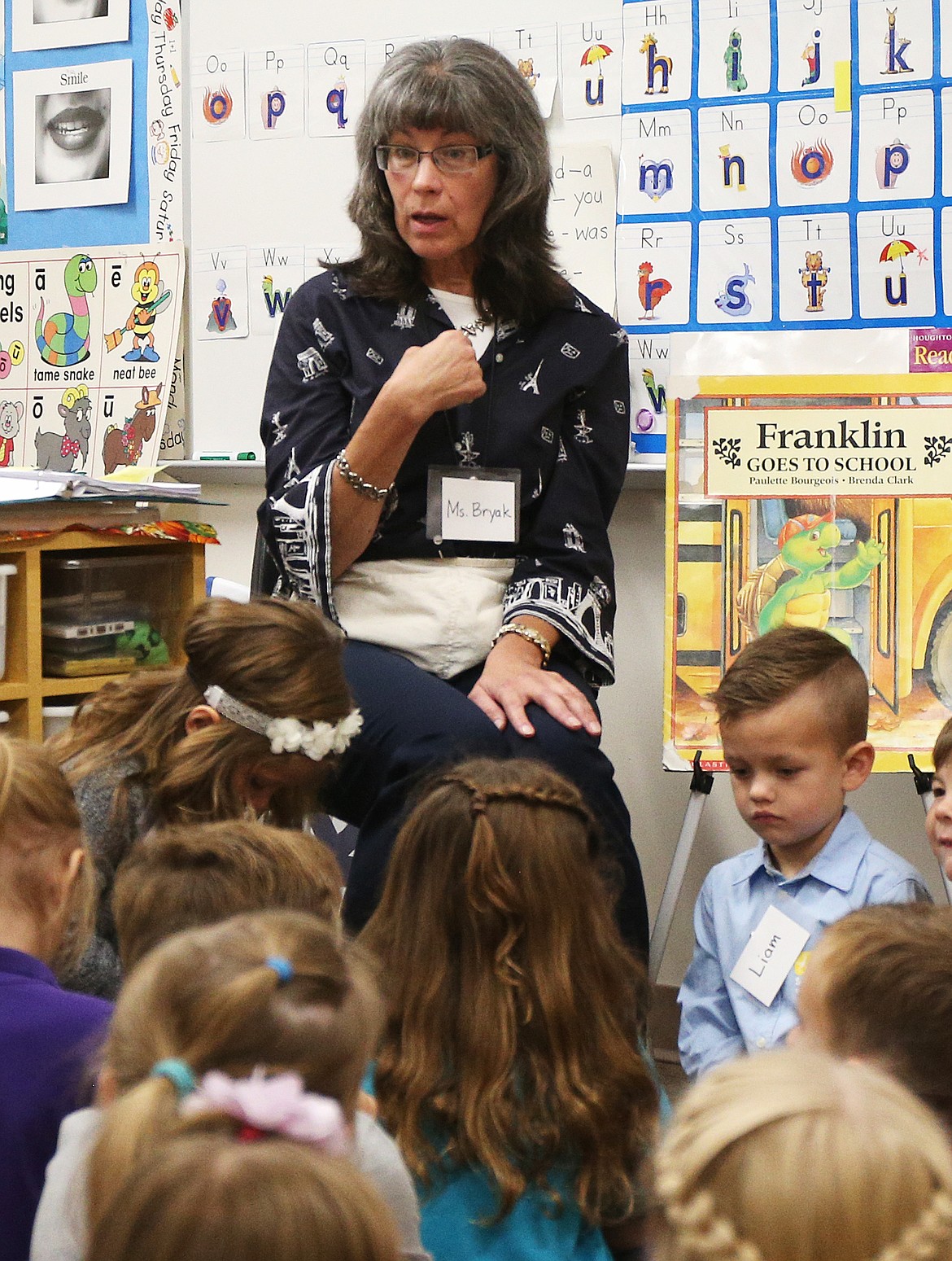 Teacher Geralyn Bryak shares a story with her kindergarten class during the first day of school at Sorensen Magnet School of the Arts and Humanities on Tuesday.