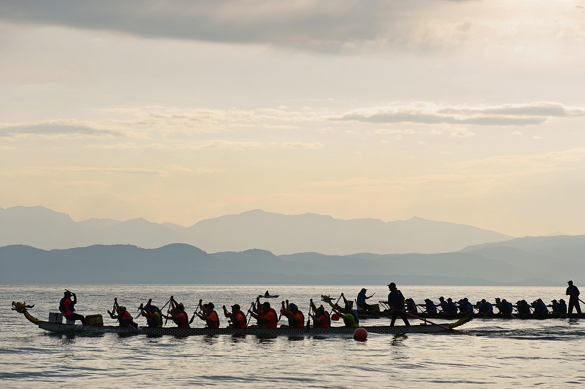 Pearly Whites, left, and Leavitt Great West, both from Kalispell, cross the finish line during the Dragon Boat Festival at Volunteer Park in Lakeside on Saturday. (Casey Kreider/Daily Inter Lake)