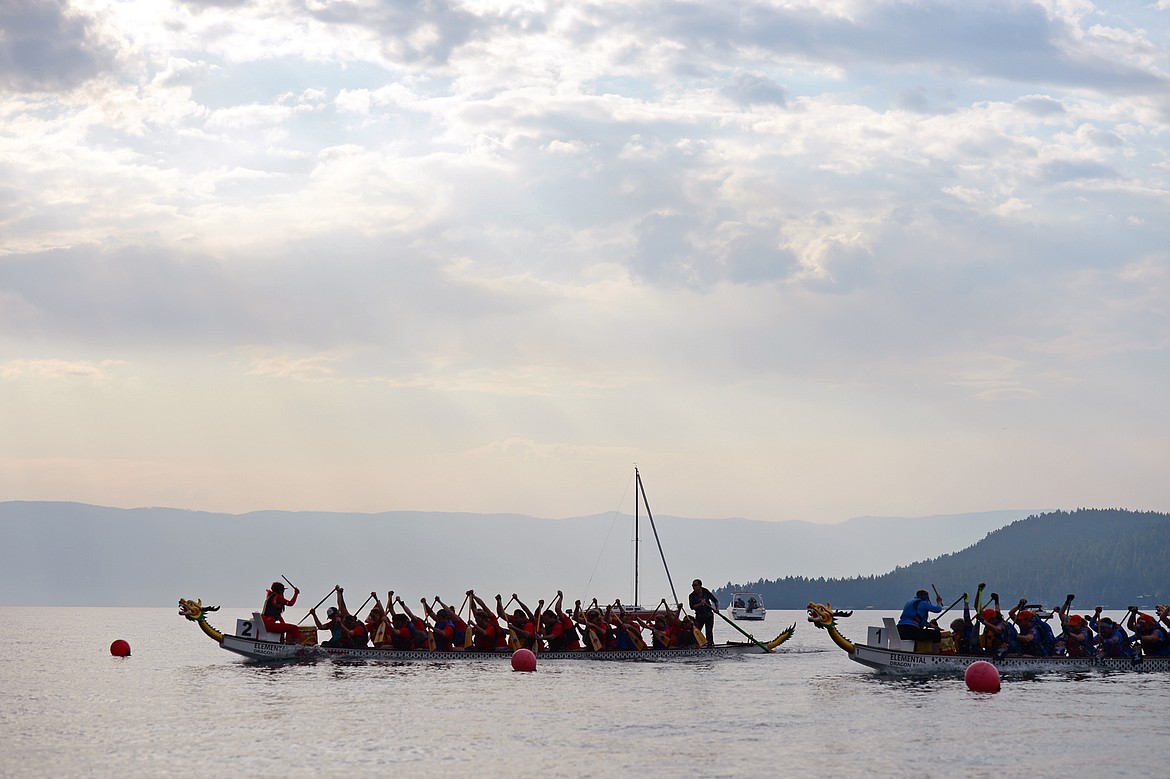 Pearly Whites, left, and Leavitt Great West, both from Kalispell, race during the Dragon Boat Festival at Volunteer Park in Lakeside on Saturday. (Casey Kreider/Daily Inter Lake)