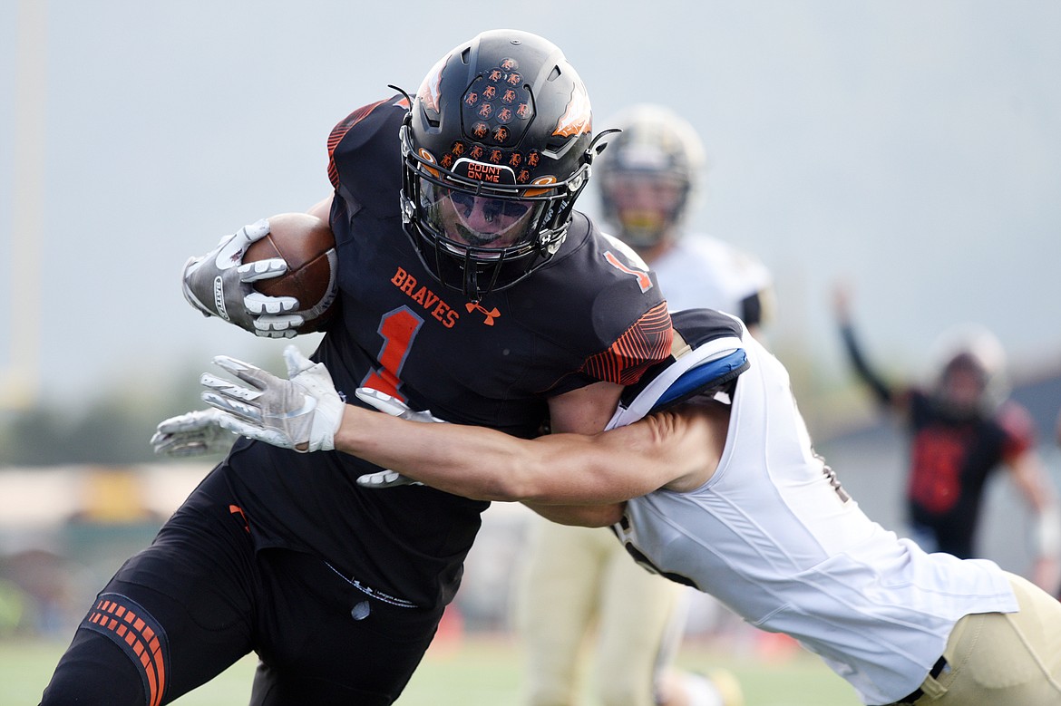 Flathead's Logan Siblerud (1) sheds a tackle by Billings West's Payton Sullivan (16) on a 20-yard touchdown reception in the second quarter at Legends Stadium on Friday. (Casey Kreider/Daily Inter Lake)