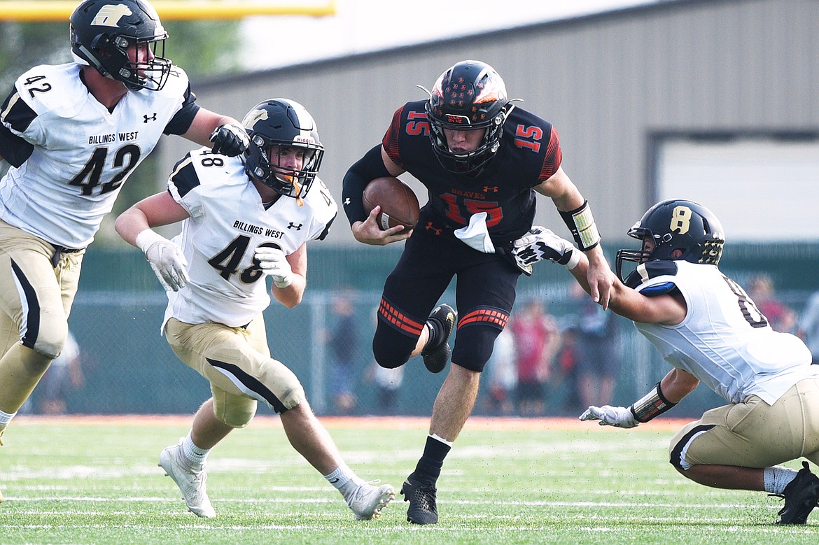 Flathead quarterback Jaden MacNeil looks for running room against Billings West at Legends Stadium on Friday. (Casey Kreider/Daily Inter Lake)