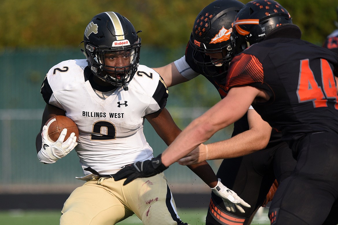 Billings West running back Demarcus Carr is brought down in the backfield by Flathead's Mason Chapman (2) and Tanner Russell (44) at Legends Stadium on Friday. (Casey Kreider/Daily Inter Lake)