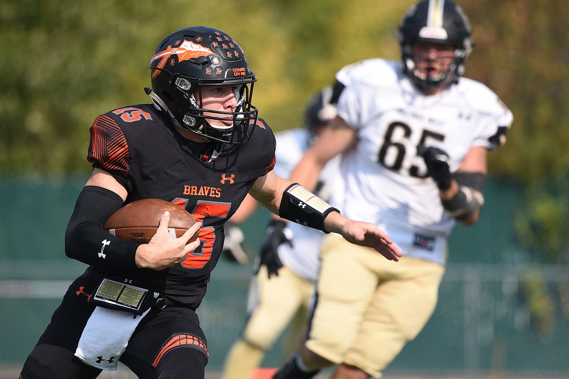 Flathead quarterback Jaden MacNeil looks for running room in the first quarter against Billings West at Legends Stadium on Friday. (Casey Kreider/Daily Inter Lake)