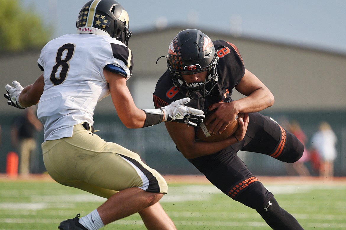 Flathead's AJ Jones (8) turns upfield after a reception with Billings West's Zack Tallman (8) defending at Legends Stadium on Friday. (Casey Kreider/Daily Inter Lake)