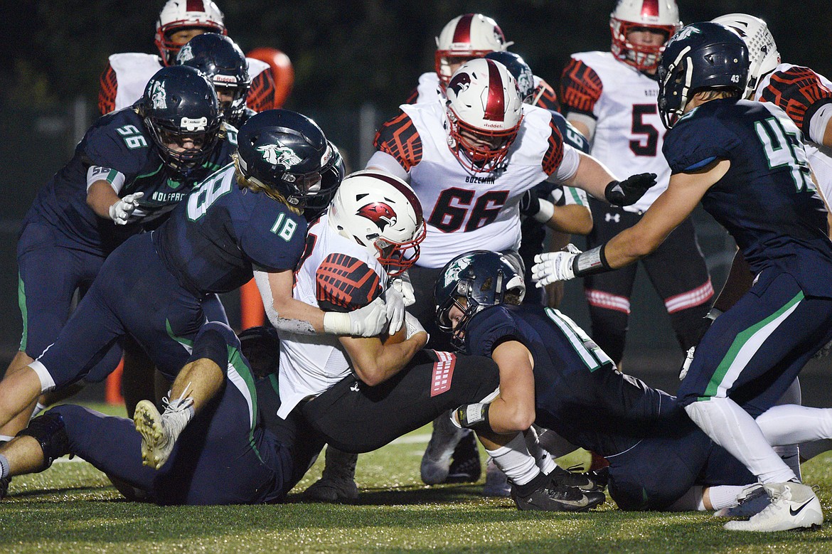 Glacier's Garret Frost (18) and Hunter Karlstad (15) bring down Bozeman running back Joe Olson on a second quarter run at Legends Stadium on Friday. (Casey Kreider/Daily Inter Lake)