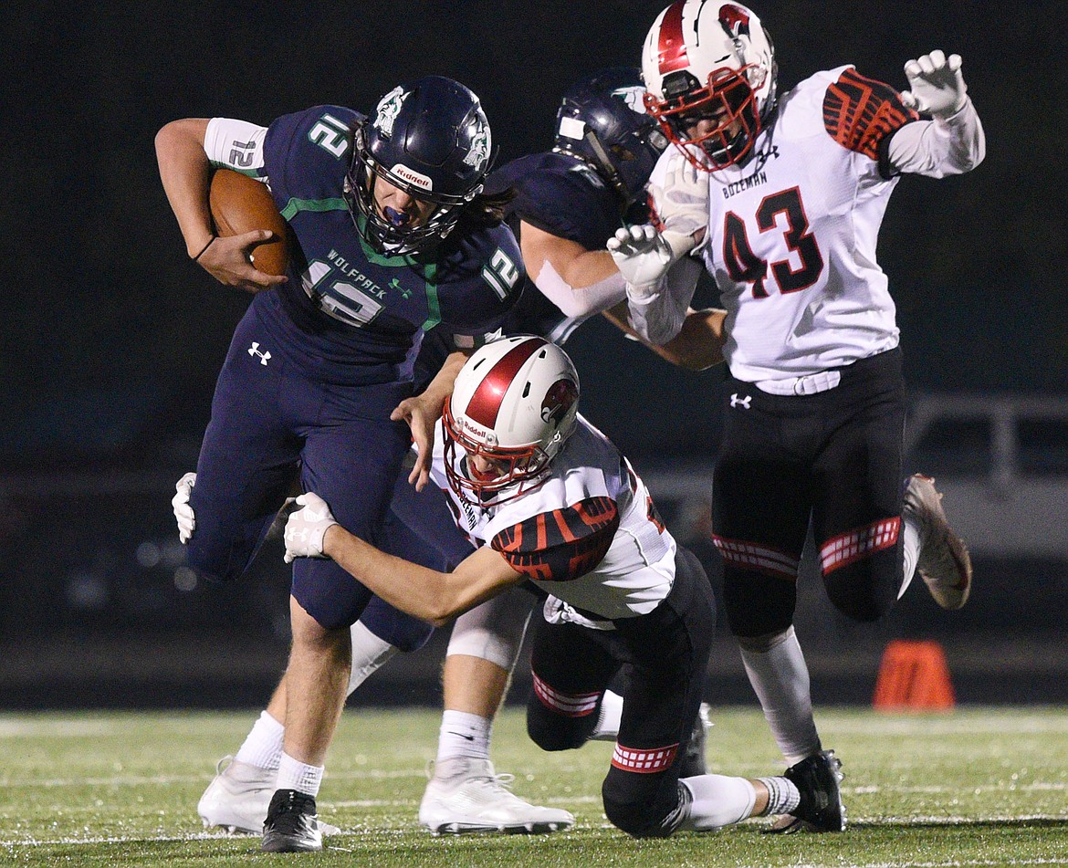 Glacier quarterback JT Allen looks for running room in the second quarter against Bozeman at Legends Stadium on Friday. (Casey Kreider/Daily Inter Lake)