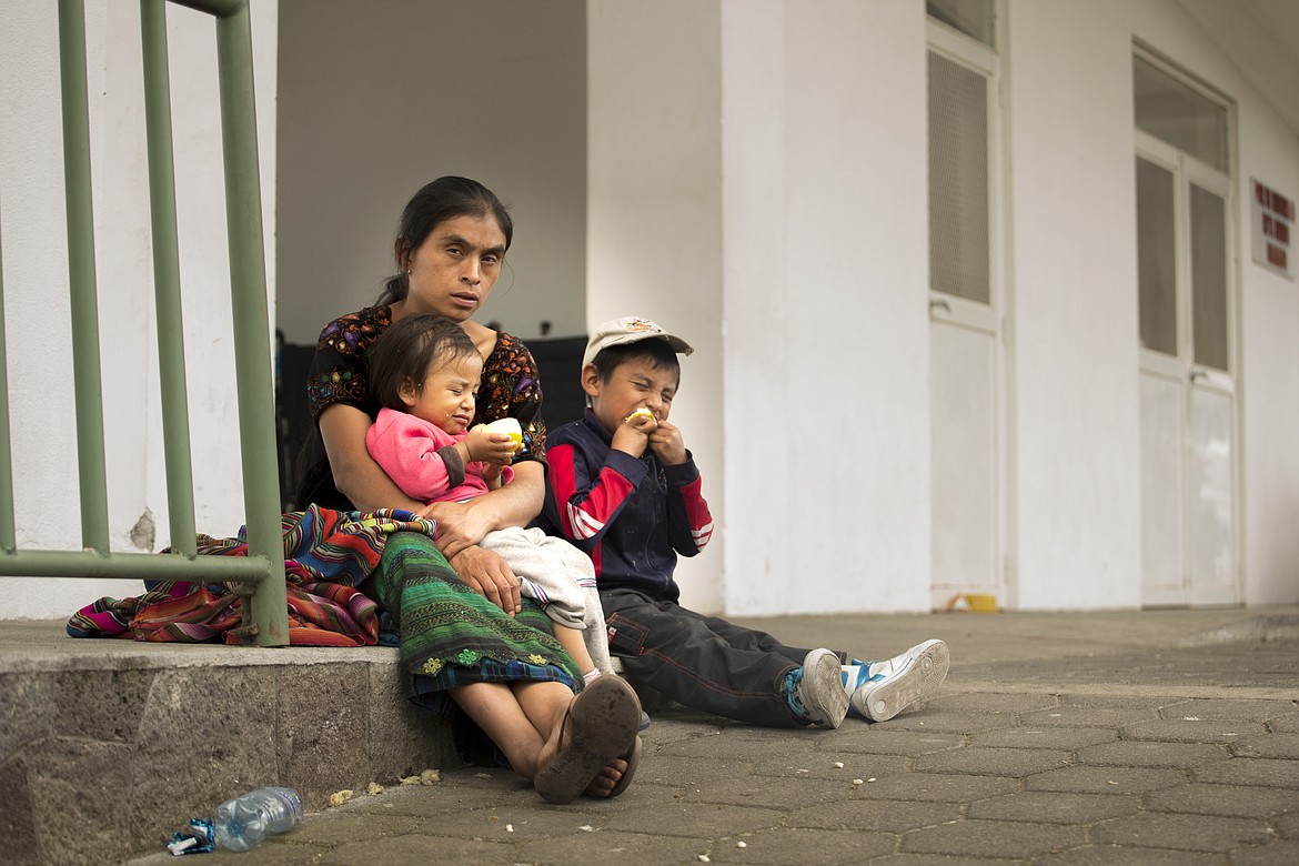 A mother in Guatemala sits with her two children who are squinting because the sun hurts their eyes. They have cataracts that limit their vision. The family will become the subject of a documentary by a Coeur d&#146;Alene filmmaker. (Courtesy photo)