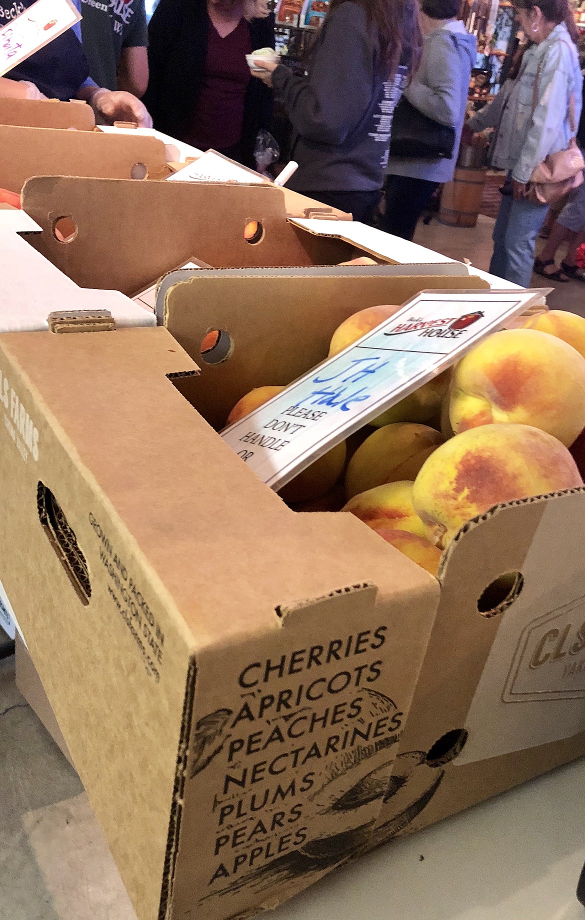 Stacks of boxes of fresh local peaches are available for sale at Beck&#146;s Harvest House at Green Bluff.