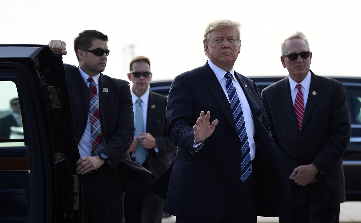 President Donald Trump waves before getting into his car after arriving at Billings Logan International Airport in Billings, Mont., Thursday, Sept. 6, 2018. Trump is in Montana for a rally. (AP Photo/Susan Walsh)