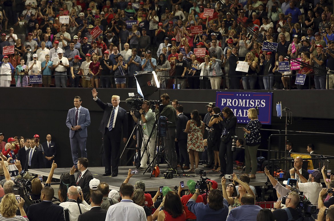 President Donald Trump finishes a television interview before speaking at a rally at the Rimrock Auto Arena in Billings, Mont., Thursday, Sept. 6, 2018. (AP Photo/Jim Urquhart)