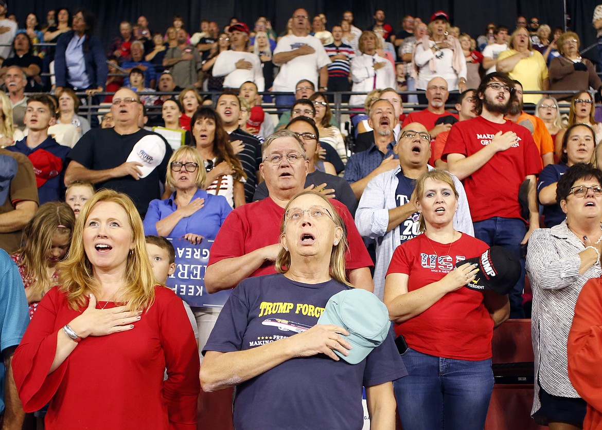 Attendees recite the Pledge of Allegiance before President Donald Trump speaks at a rally at the Rimrock Auto Arena in Billings, Mont., Thursday, Sept. 6, 2018. (AP Photo/Jim Urquhart)