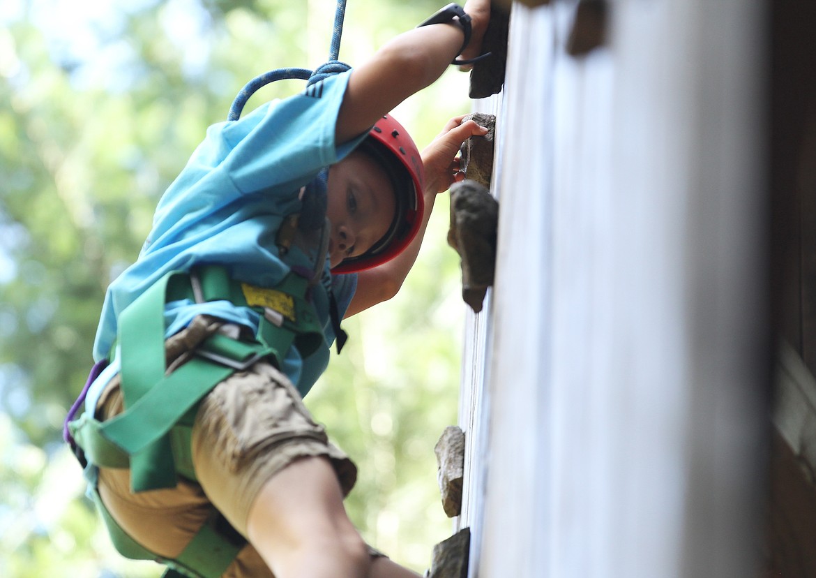 Collin Rzepa, 7, of Coeur d&#146;Alene, scales a climbing wall at Camp Lutherhaven on Saturday during the fourth annual North Idaho Veteran Family Retreat. About 15 families participated in the retreat, which is annually held to build community among local veterans as well as give them and their loved ones a weekend to relax and be together. Collin is the son of a disabled Purple Heart veteran and his mom, Cassandra, is a family assistance center specialist for Idaho Joint Military Family Programs. (DEVIN WEEKS/Press)