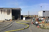 Travel trailer charred, shop damaged in blaze