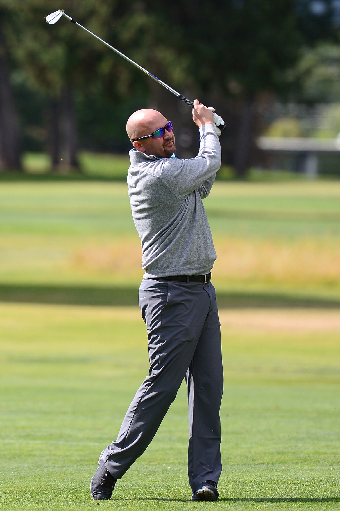 Justin Dorr, of Spokane, Washington, hits his approach on hole eight of the Cameron 9 course during the Labor Day Tournament at Buffalo Hill Golf Club in Kalispell on Saturday. (Casey Kreider/Daily Inter Lake)