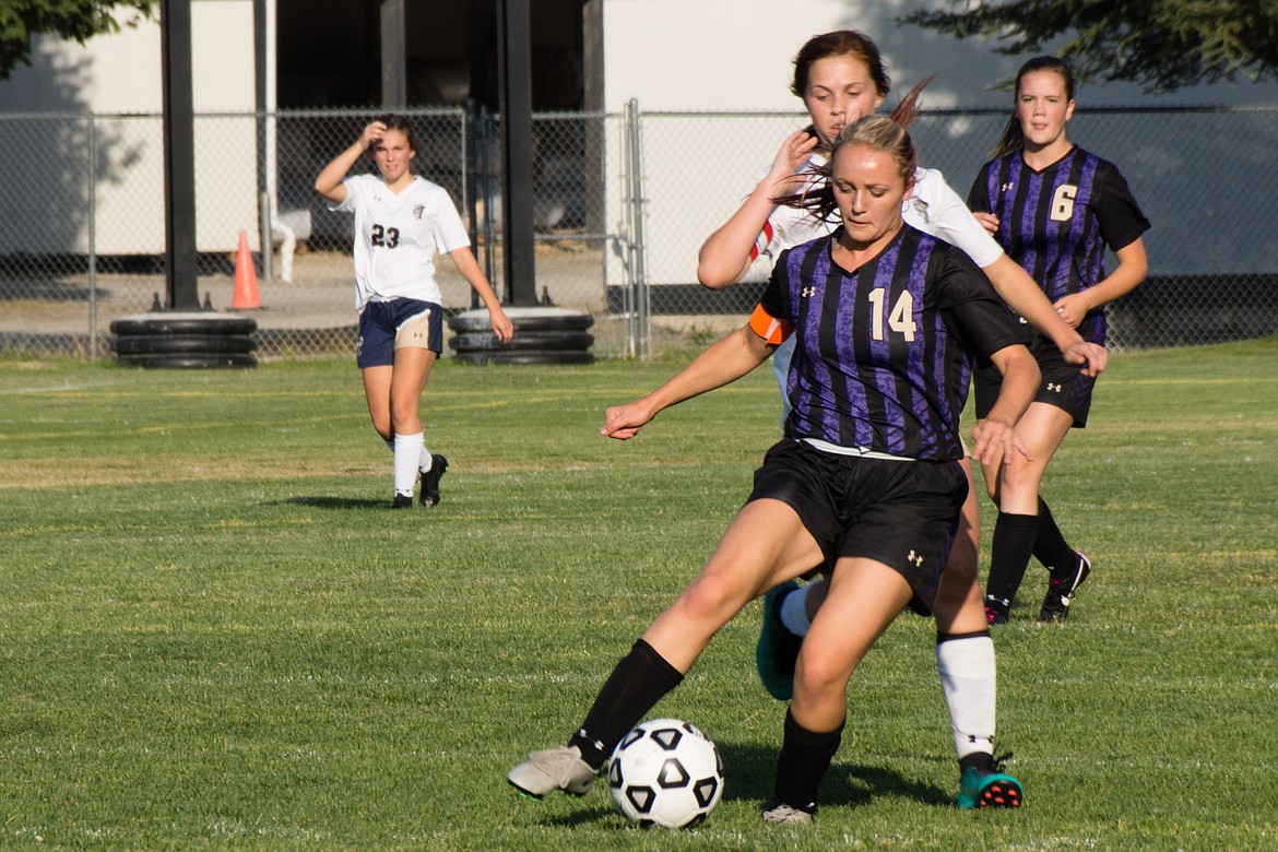 Photo by Jeff Green/ Taeya Sheppard dribbles through Timberlake defenders during the Wildcats' match against Timberlake.