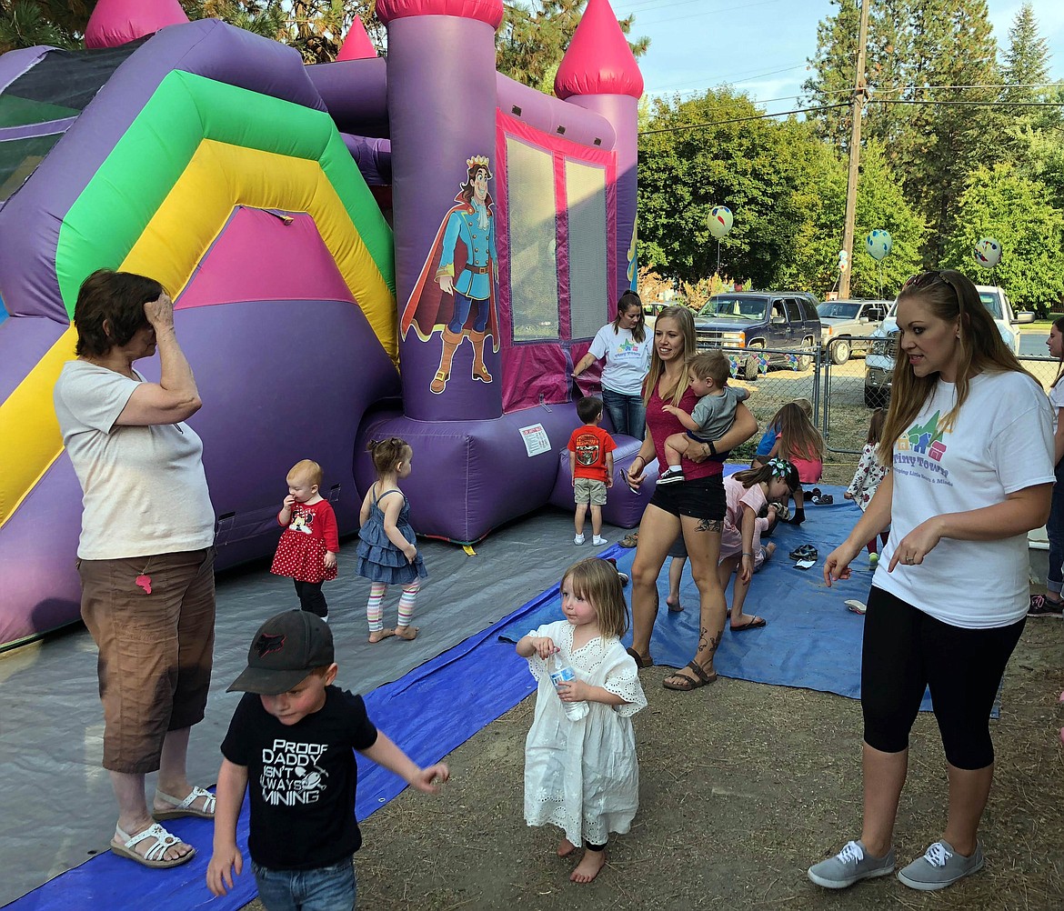 Daycare clients and their families were treated to a fun party for the one-year celebration, which included a pizza party and even a bouncy house with a slide.