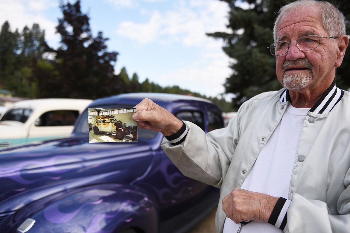 Dennis Andersen, of Tacoma, Washington, holds a photo of his 1940 Ford before he fully restored it outside VFW Post 4042 in Bigfork. Andersen said he spent about 10 years customizing and restoring the two-door sedan. (Casey Kreider/Daily Inter Lake)