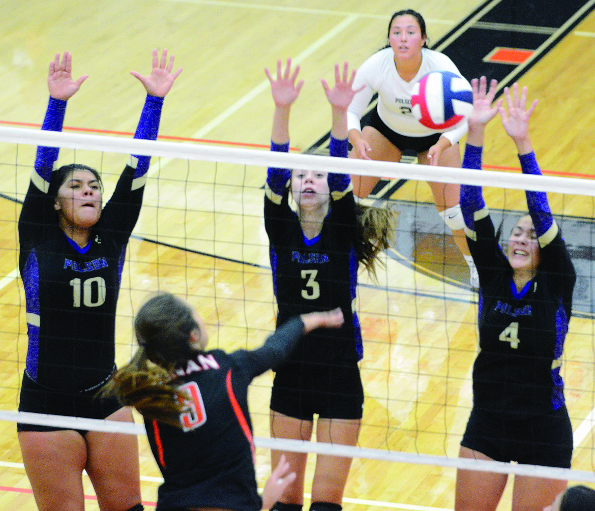 POLSON HIGH School volleyball players Olivia Perez (10), Mikaela DuCharme (3), and Paige Noyes converge on Micalann McCrea (9) while Kaylanna DesJarlais (2) protects the Lady Pirates&#146; backcourt. (Jason Blasco/Lake County Leader)