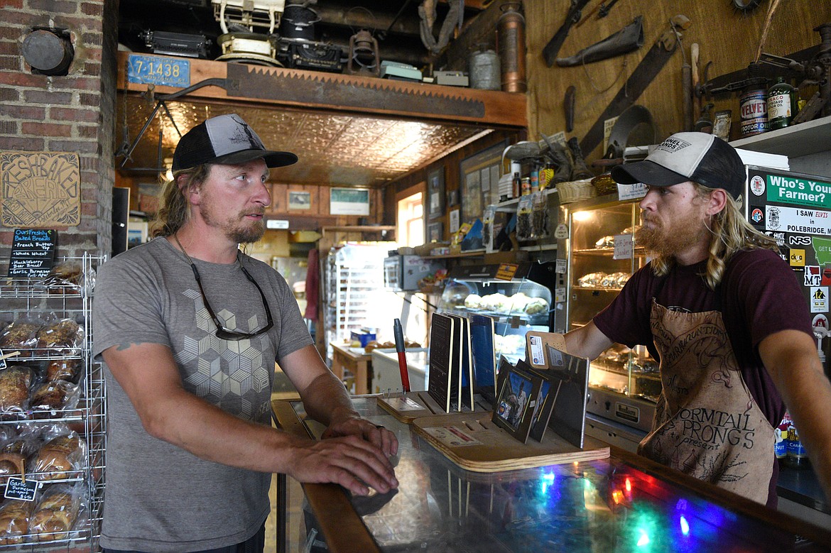 Polebridge Mercantile owner Will Hammerquist, left, talks with operations manager Jacob Janes.