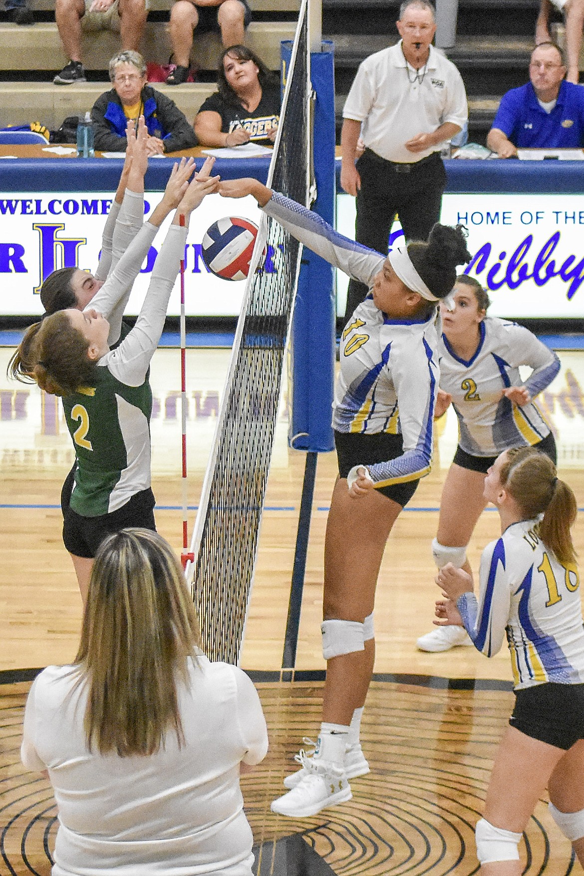 Libby senior Mehki Sykes gets a kill under the attempted block during the Lady Loggers&#146; 3-1 win over Whitefish Saturday. (Ben Kibbey/The Western News)