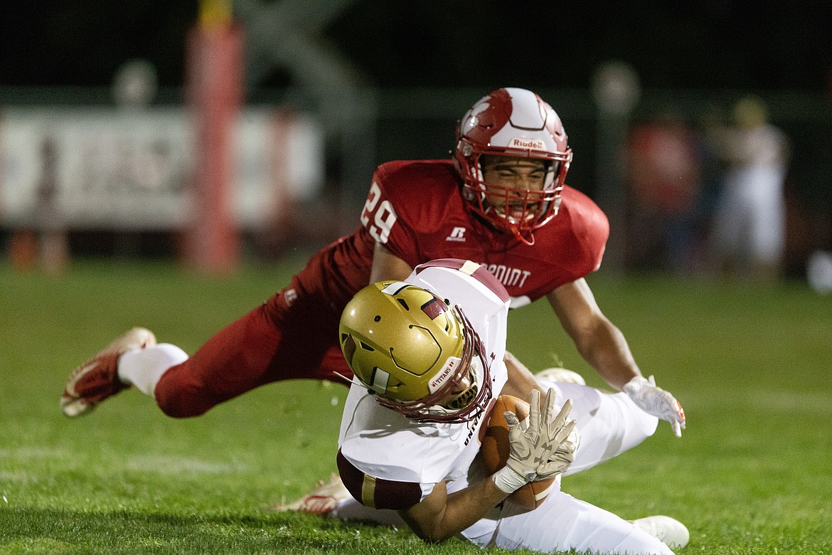 (Photo by JASON DUCHOW PHOTOGRAPHY)
Sandpoint senior corner Riley Anderson tackles a University receiver.