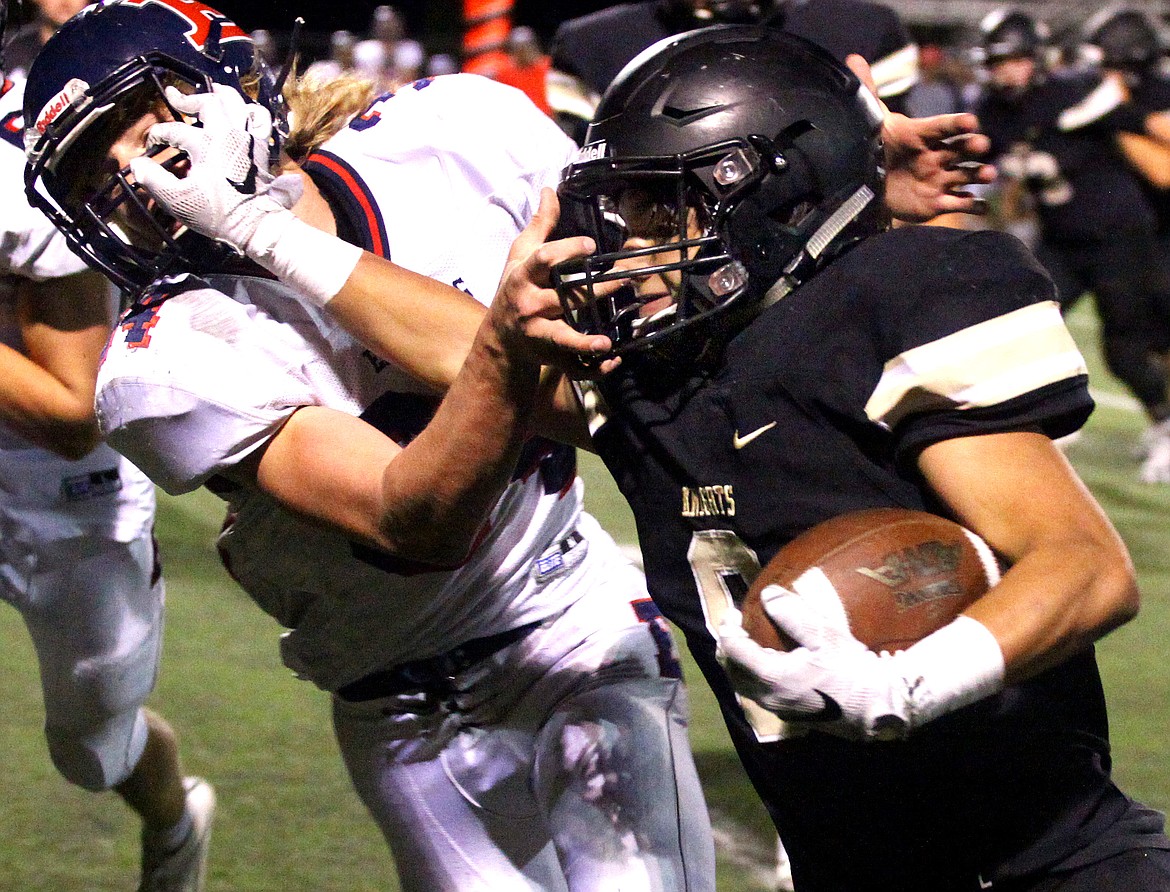 Rodney Harwood/Columbia Basin Herald
Royal running back Lorenzo Myrick (8) puts the straight arm on Ellensburg defender Brandon Mellergaard (54) during the third quarter of Fridays nonleague game at David Nielsen Stadium.
