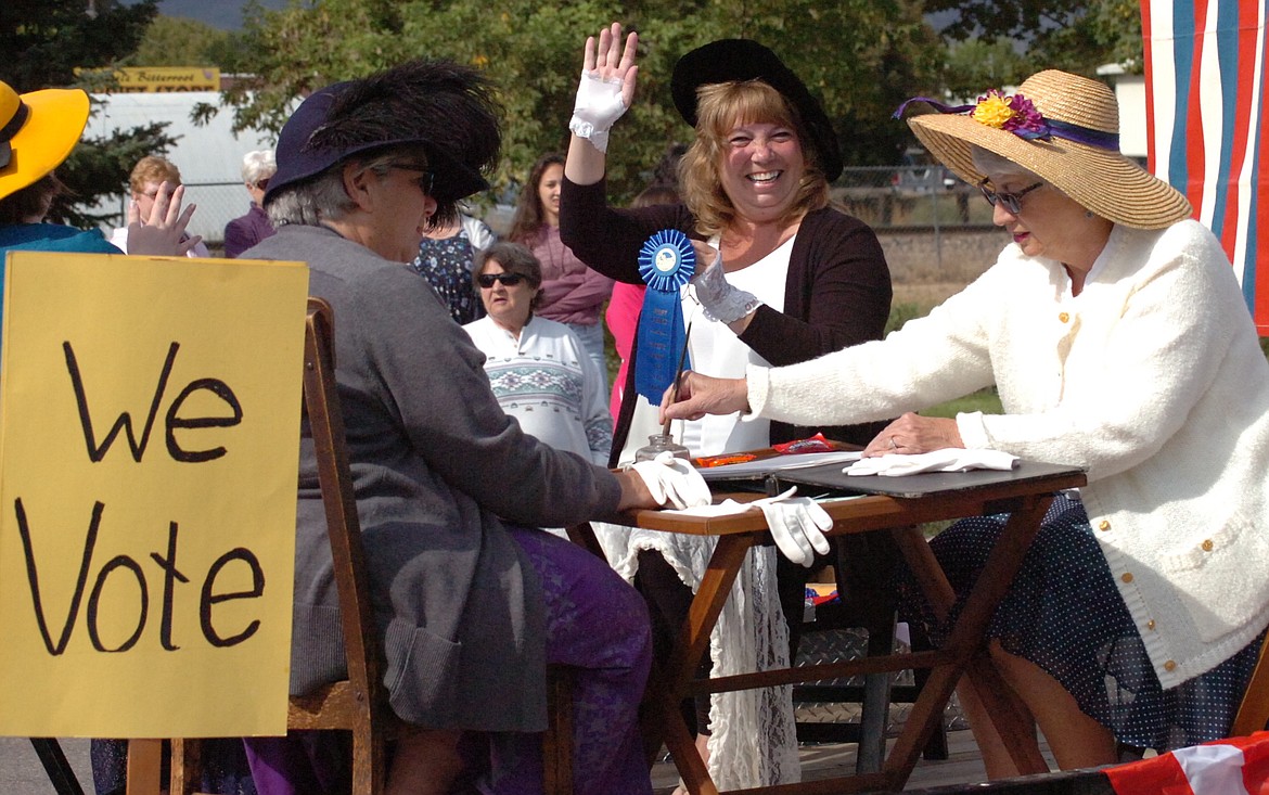 While two members of the Plains Woman's Club depict the voting process, another shows the blue ribbon the float won during the Sanders County Fair Parade.  (Joe Sova/Clark Fork Valley Press)