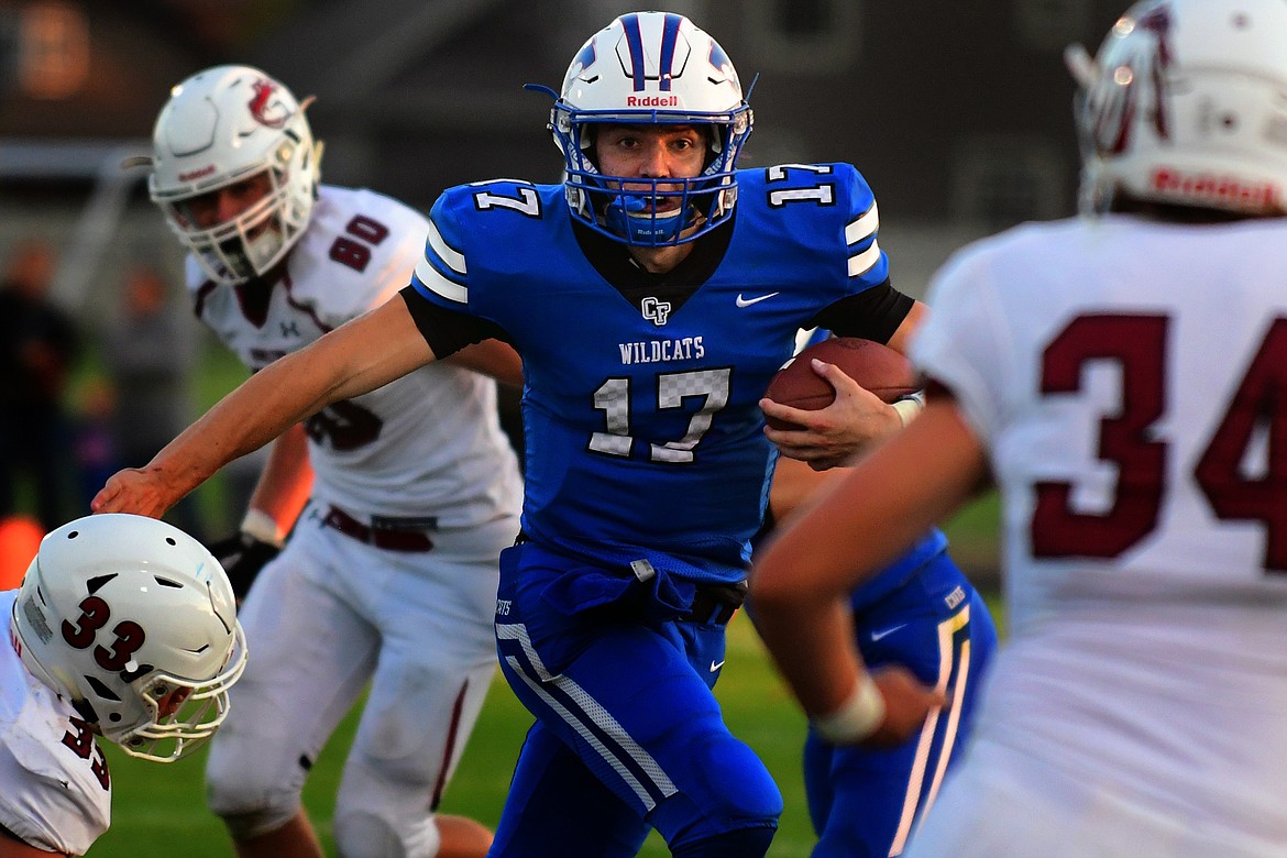 Columbia Falls quarterback Drew Morgan looks for room to run in the second quarter against Hamilton. (Jeremy Weber photo)