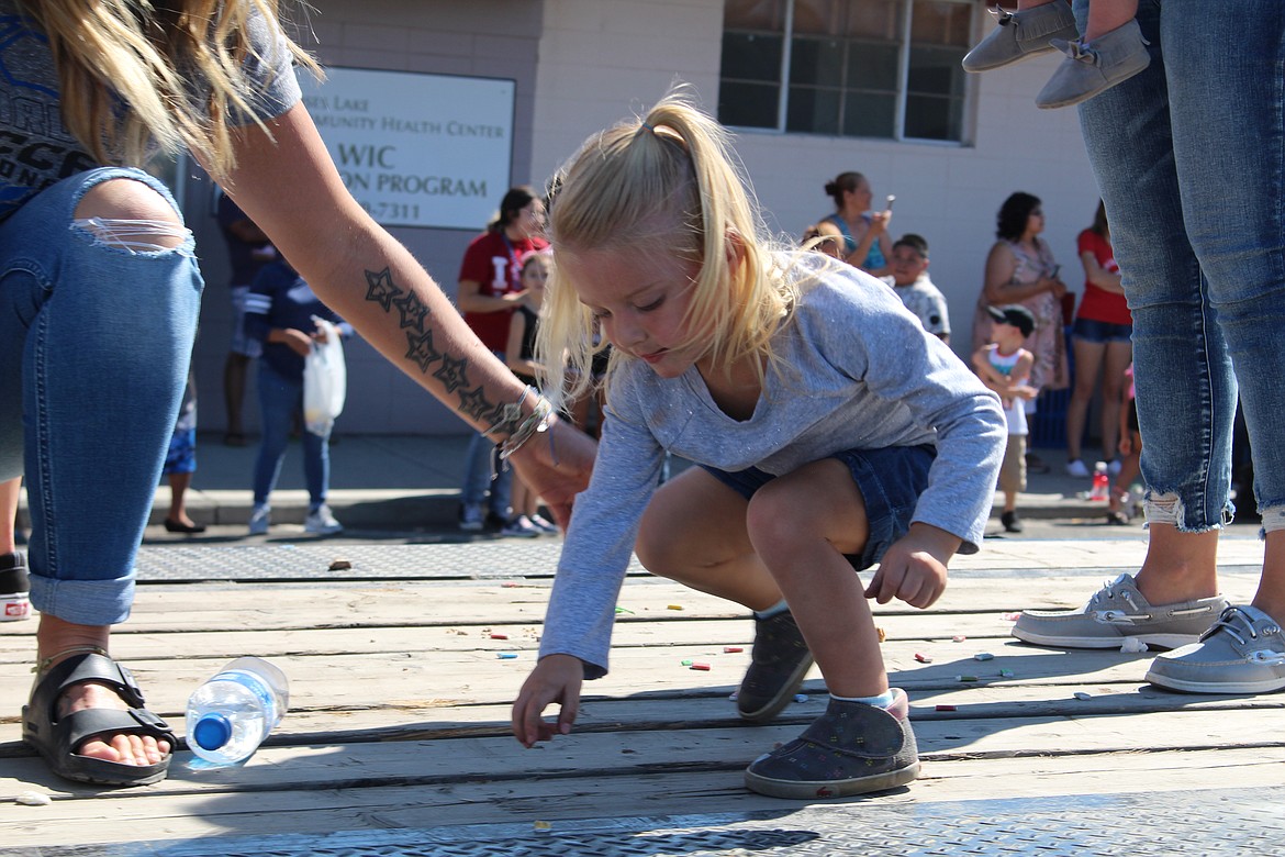 Cheryl Schweizer/Columbia Basin HeraldThe bag holding candy broke, so the crew on the Warden High School soccer team had to pick up the candy before they could throw it. The float was part of the annual Community Days parade Monday.