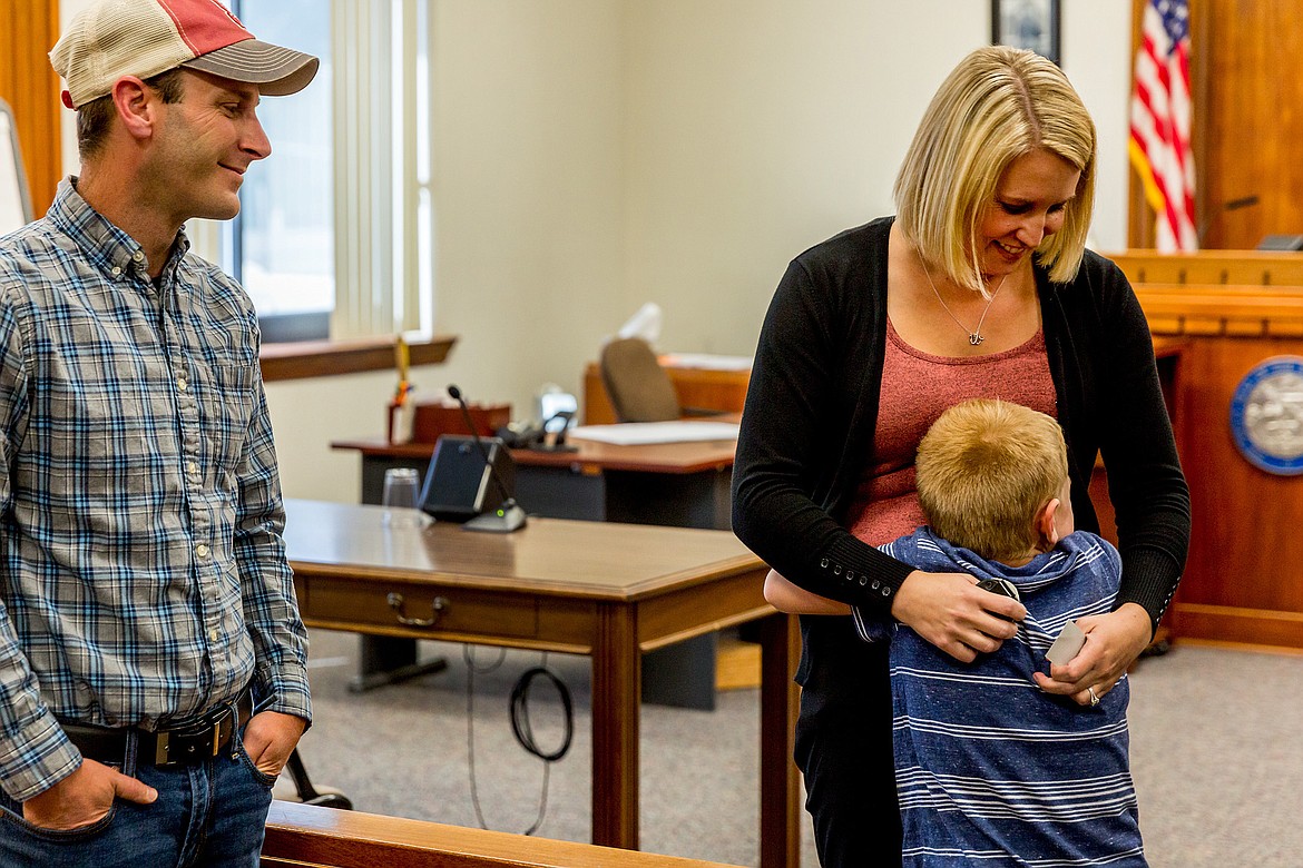 LEFT: Vanessa Williamson is hugged by her son Brevin, 6, as her husband Calen Williamson looks on in Montana 19th Judicial District Court Friday, Aug. 31. Vanessa Williamson had just been sworn in as Lincoln County&#146;s first probation officer. (John Blodgett/The Western News)