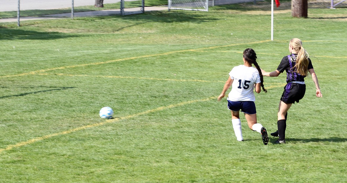 Lora Allred, right, shoots the ball toward the goal for her first goal of the season in the Wildcats&#146; 2-1 win over the Badgers.